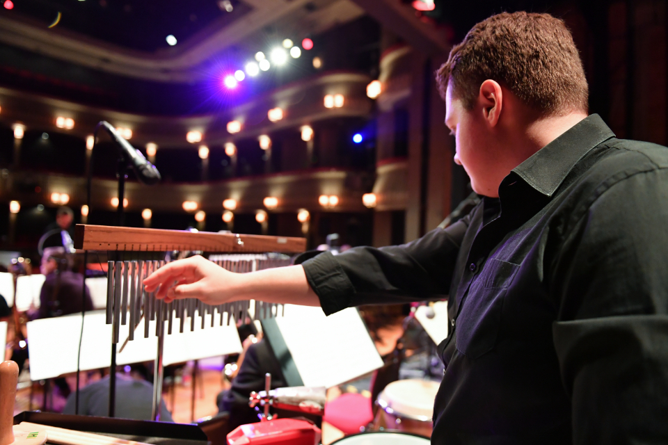 A student playing percussion in the RCM's Jazz Orchestra in the Britten Theatre